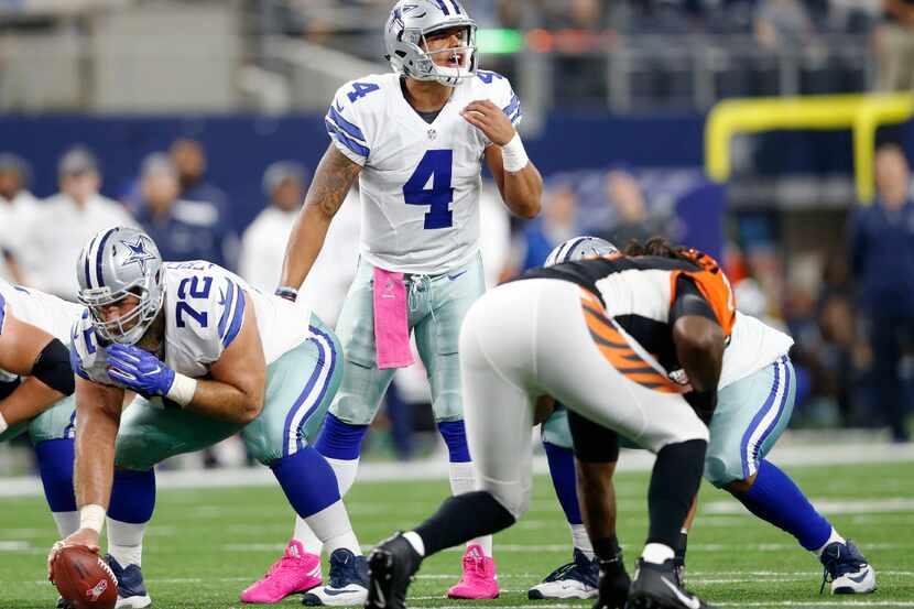 Cowboys quarterback Dak Prescott (4) communicates to his teammates at the line of scrimmage...