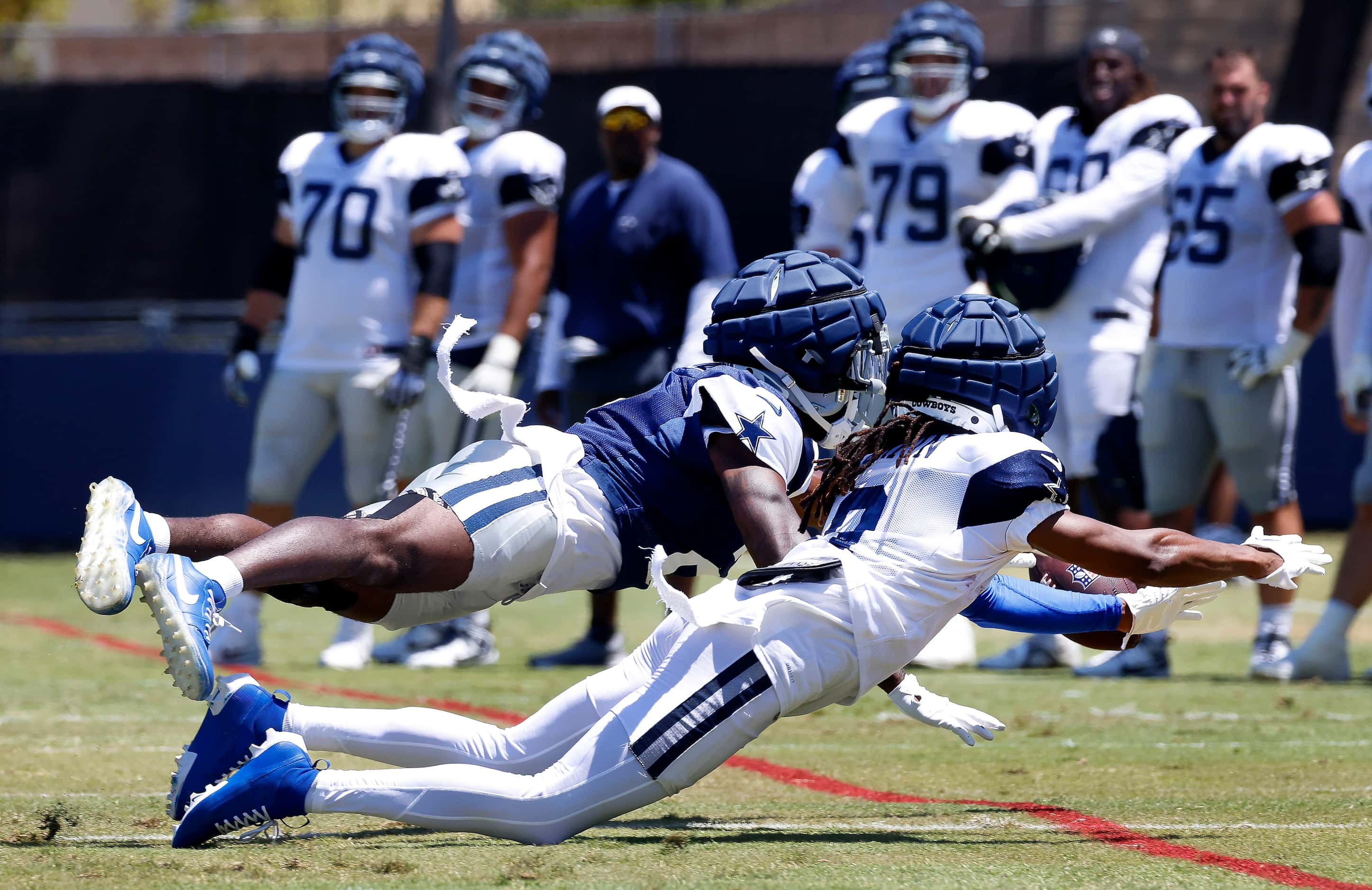 Dallas Cowboys cornerback Jourdan Lewis (2, top) lays out to deflect a pass intended for...