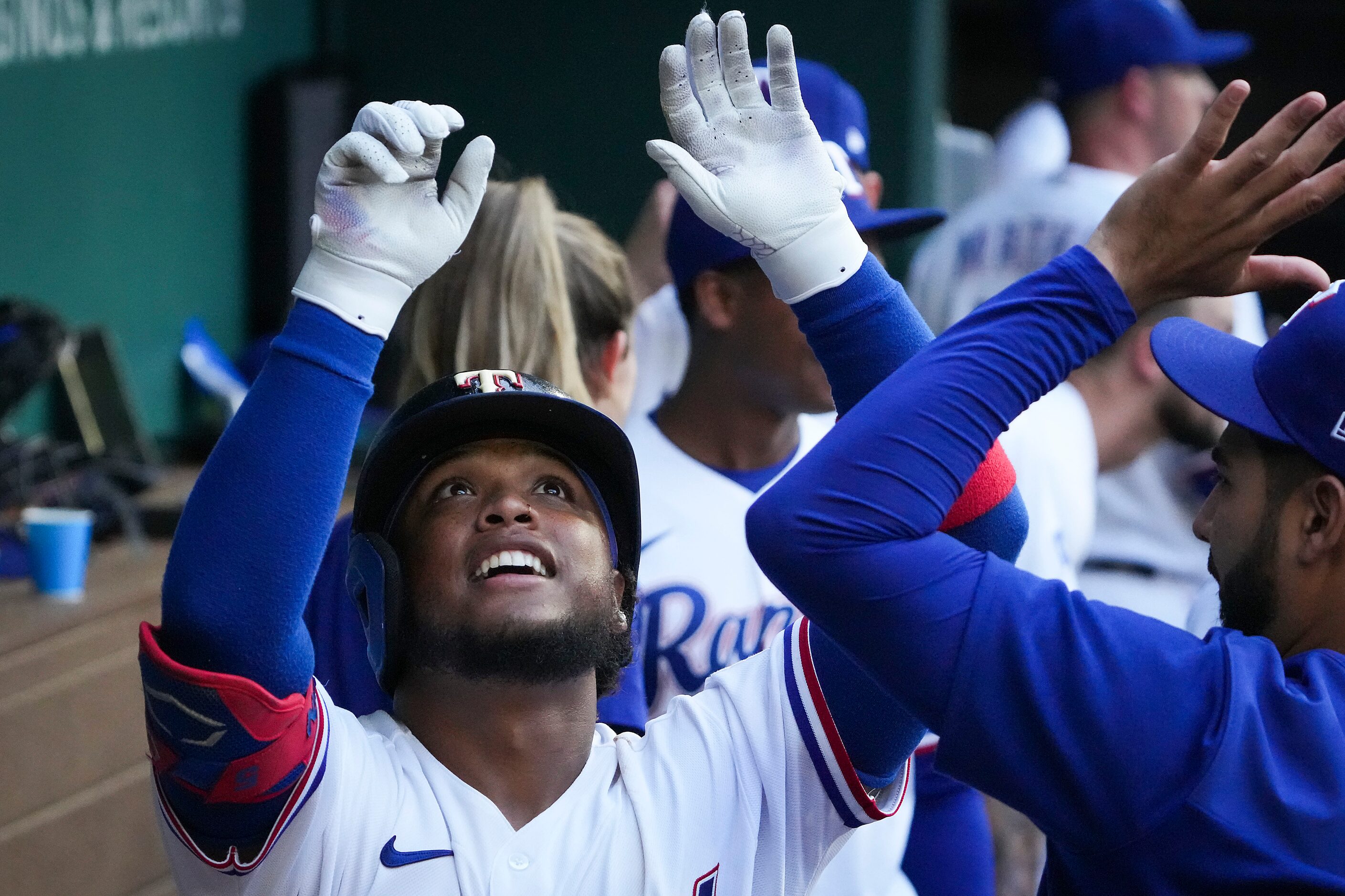 Texas Rangers pinch hitter Willie Calhoun celebrates after hitting a solo home run to tie...