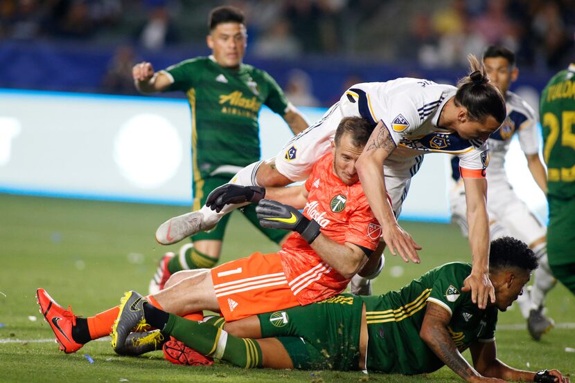 CARSON, CALIFORNIA - MARCH 31:  Zlatan Ibrahimovic #9 of Los Angeles Galaxy falls over Jeff...