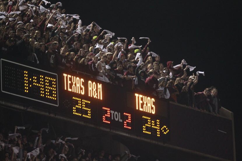 Texas A&M fans cheer as the held a lead during the second half of their Thanksgiving day...