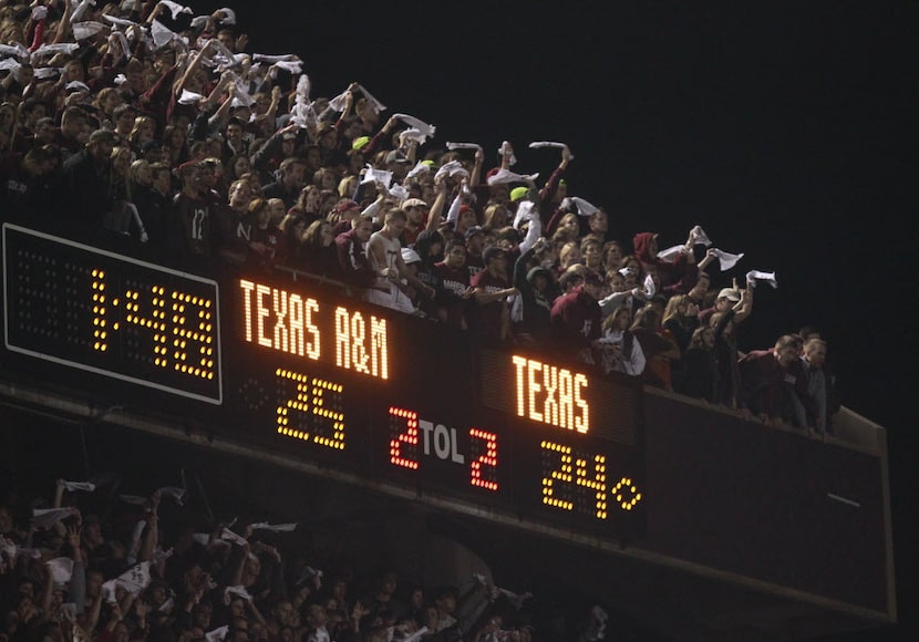 Texas A&M fans cheer as the held a lead during the second half of their Thanksgiving day...