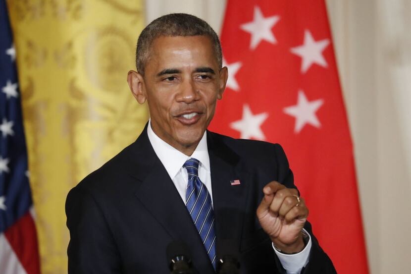 President Barack Obama answers questions during a joint news conference with Singapore's...