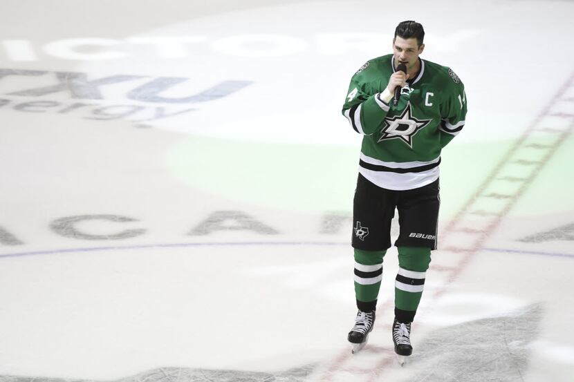 Dallas Stars left wing Jamie Benn (14) talks to fans after an NHL hockey game on Saturday,...