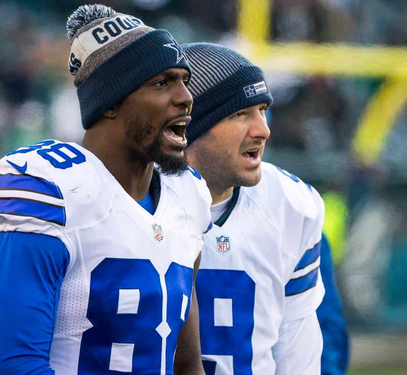 Dallas Cowboys quarterback Tony Romo (9) and wide receiver Dez Bryant (88) watch from the...