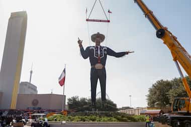 A crane lifts Big Tex into place at The State Fair of Texas, Friday, Sept. 23, 2022 in Dallas.