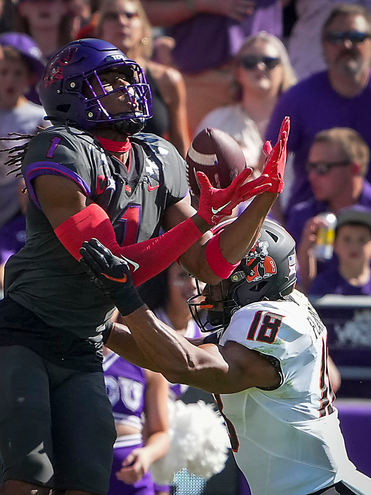 TCU wide receiver Quentin Johnston (1) catches a pass over Oklahoma State safety Sean...