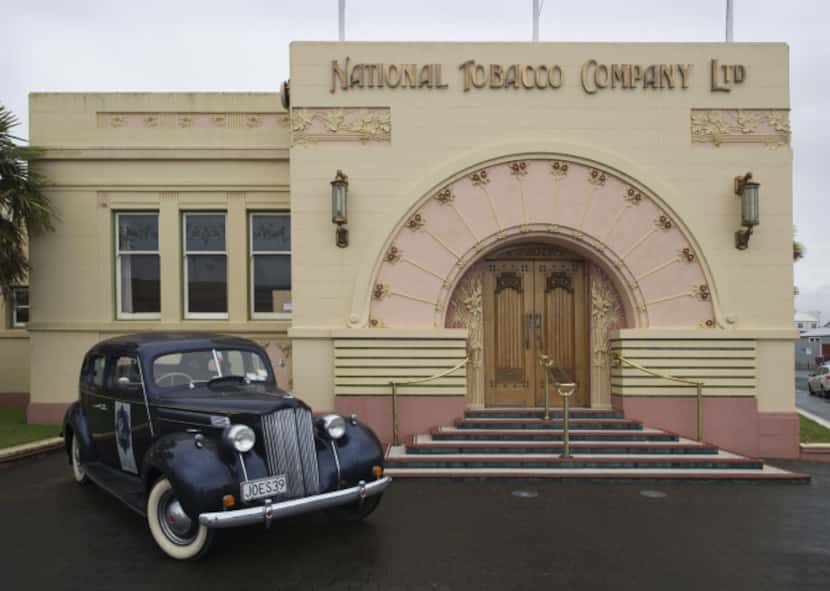 A Packard Six car sits outside Napier, New Zealand's 1933-built National Tobacco Company...