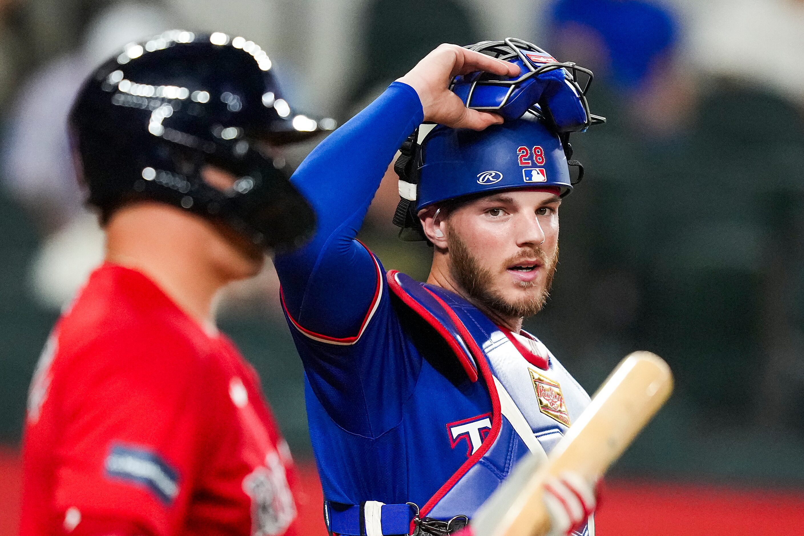 Texas Rangers catcher Jonah Heim looks to the dugout during the third inning of an...