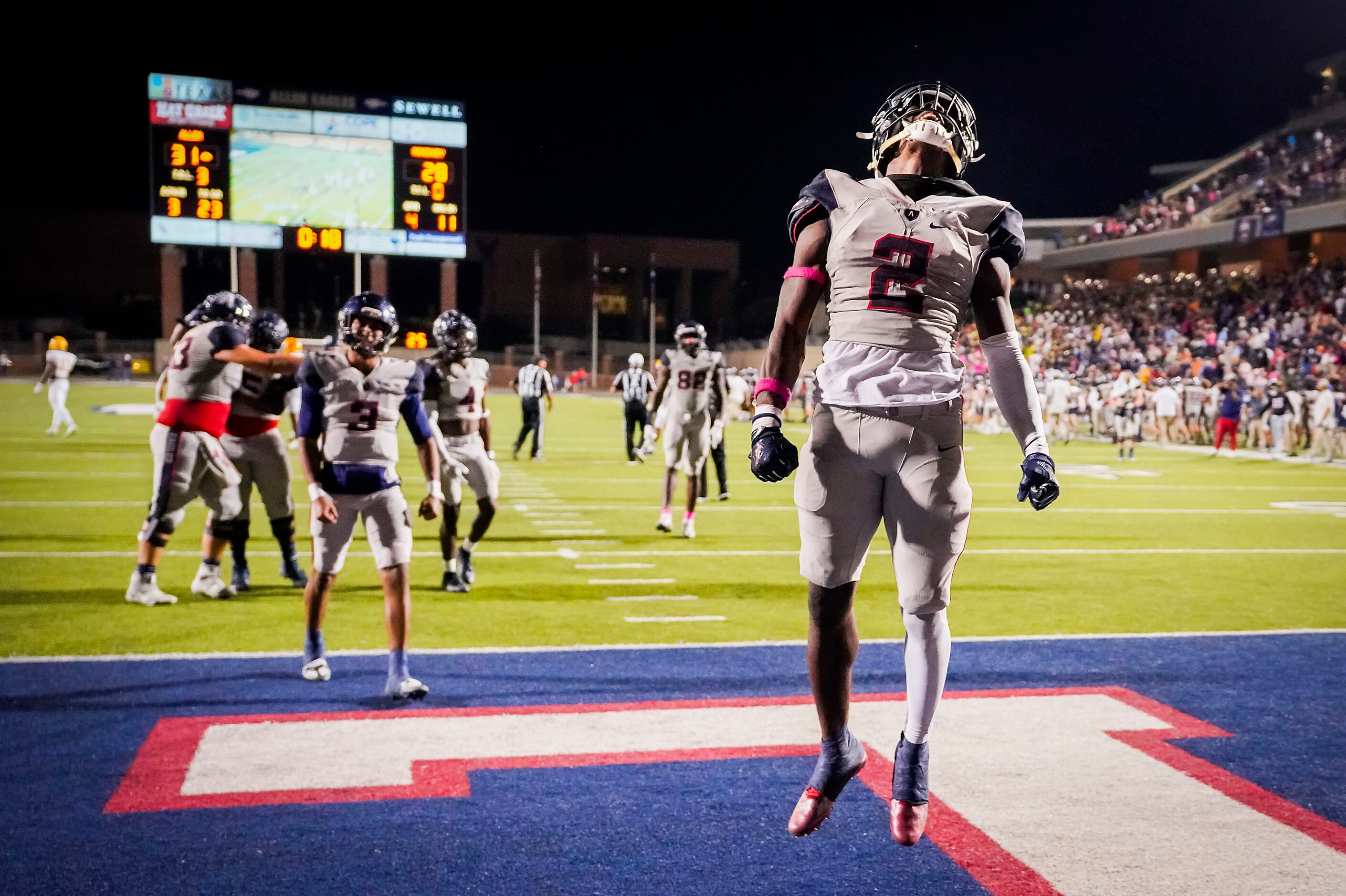 Allen running back Kayvion Sibley (2) and quarterback Mike Hawkins (3) celebrate as the...