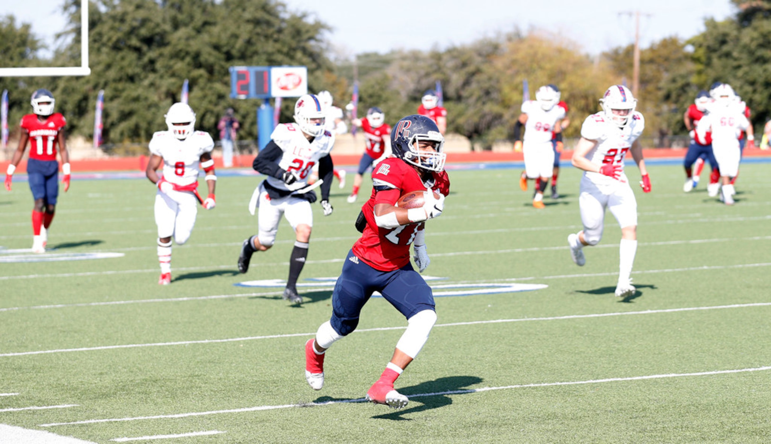 Plano John Paul II's Shunte Nettles (21) runs up the sideline for a touchdown in a game...