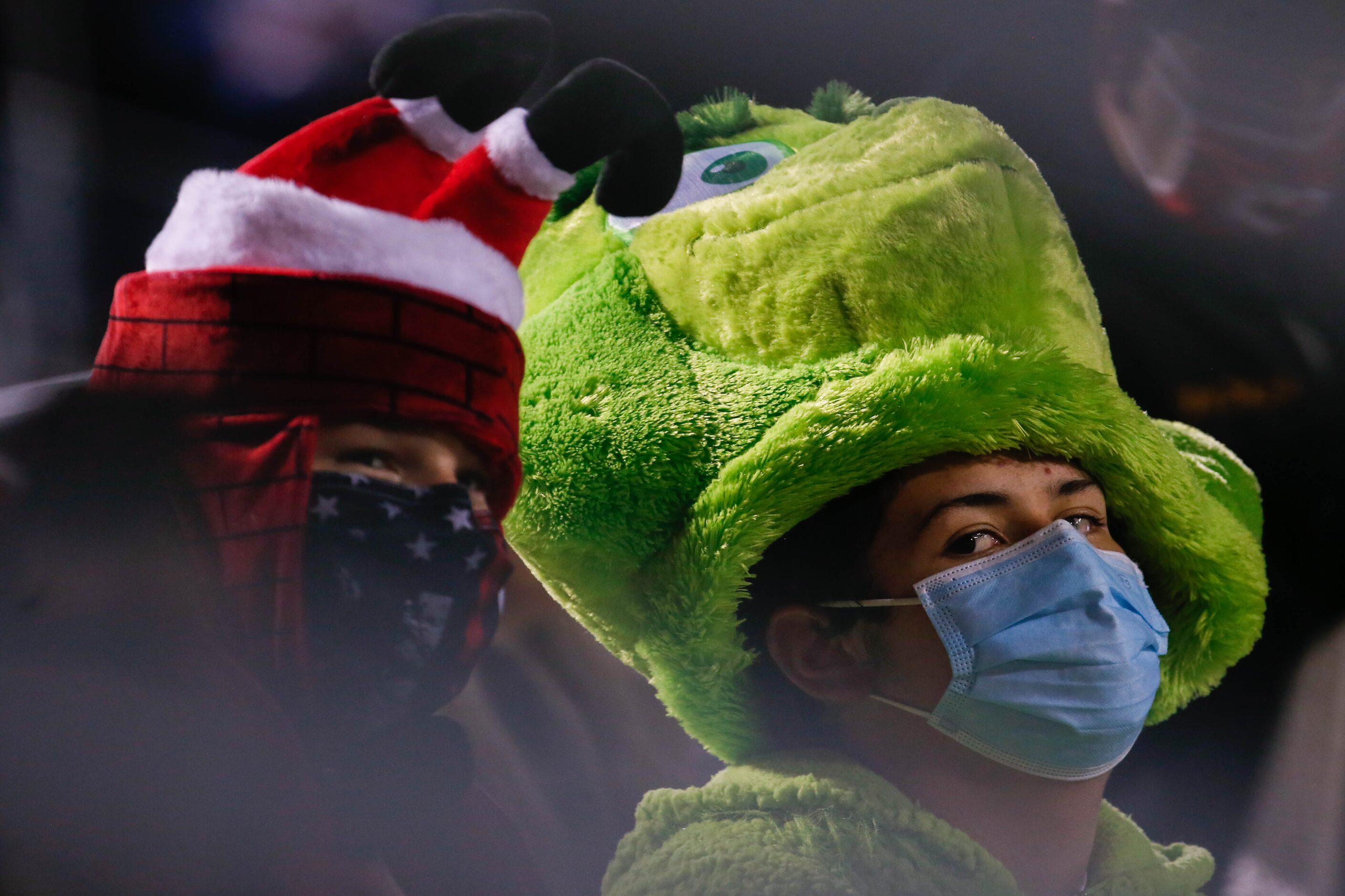 Frisco Lone Star fans Carter Tibbits, 13, (left) dressed as "sexy Santa" and Austin...