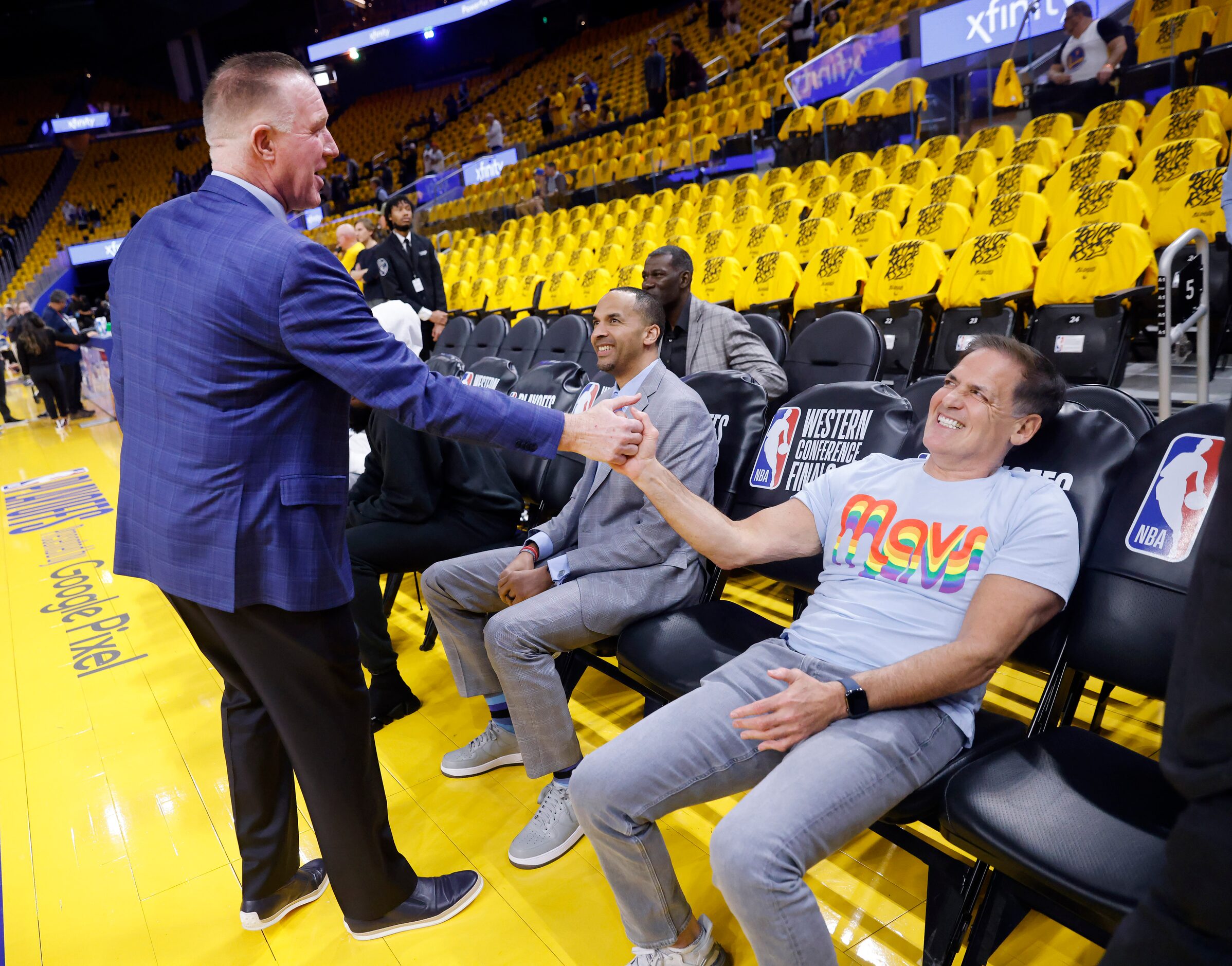 Dallas Mavericks owner Mark Cuban (right) shakes hands with former Golden State Warriors...