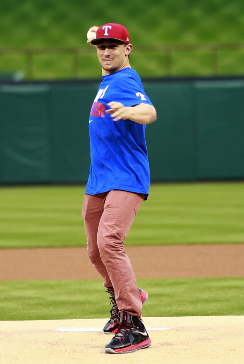 Texas A & M quarterback and 2013 Heisman trophy winner Johnny Manziel throws the first pitch...