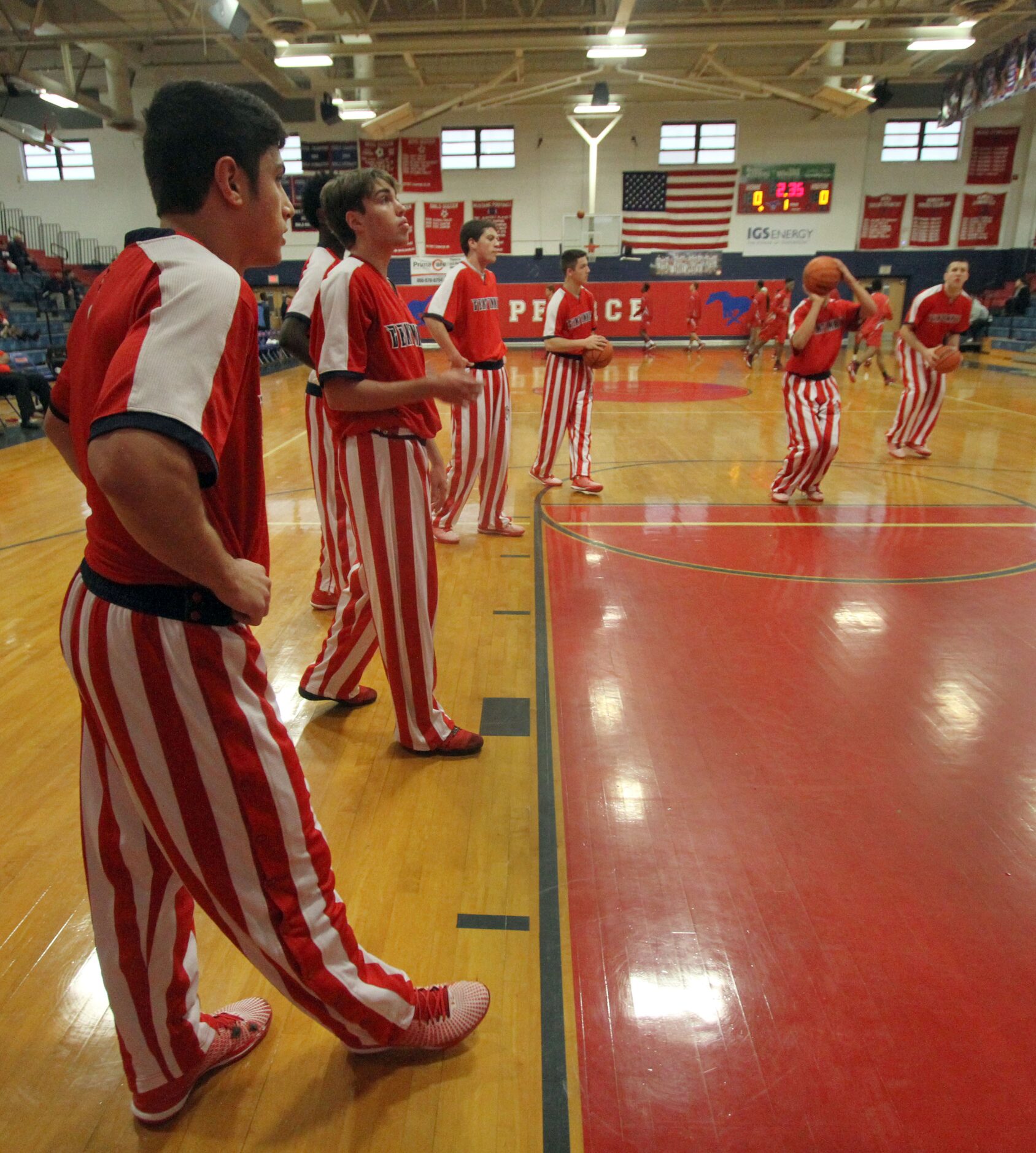 Members of the Frisco Centennial Titans warm up prior to the start of their game against...