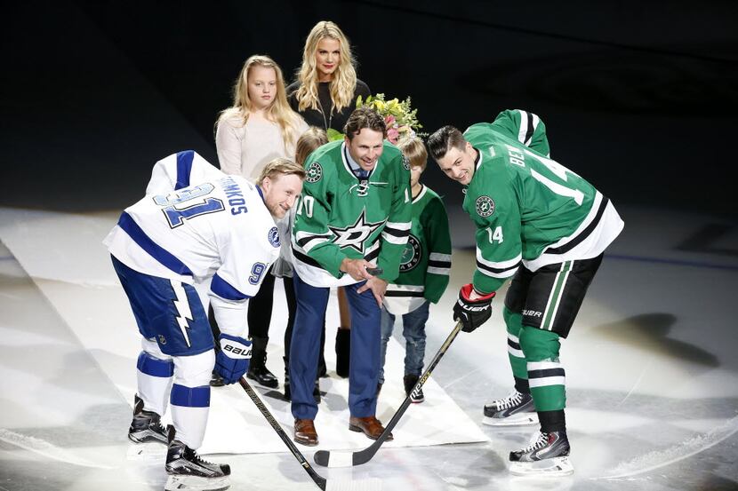 Former Dallas Stars player Brenden Morrow, center, drops the puck in a retirement ceremony...