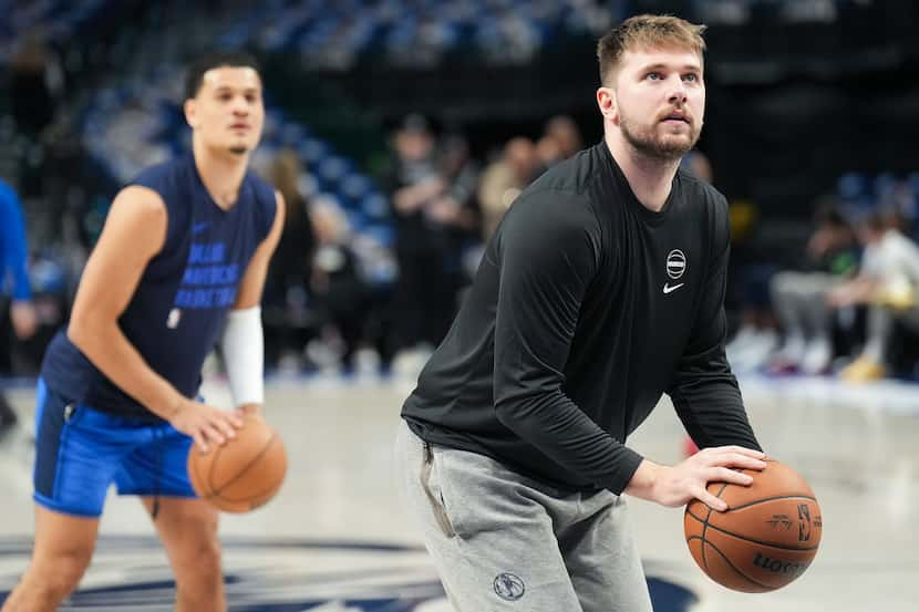 Dallas Mavericks guard Luka Doncic and guard Josh Green warm up before Game 3 of the NBA...