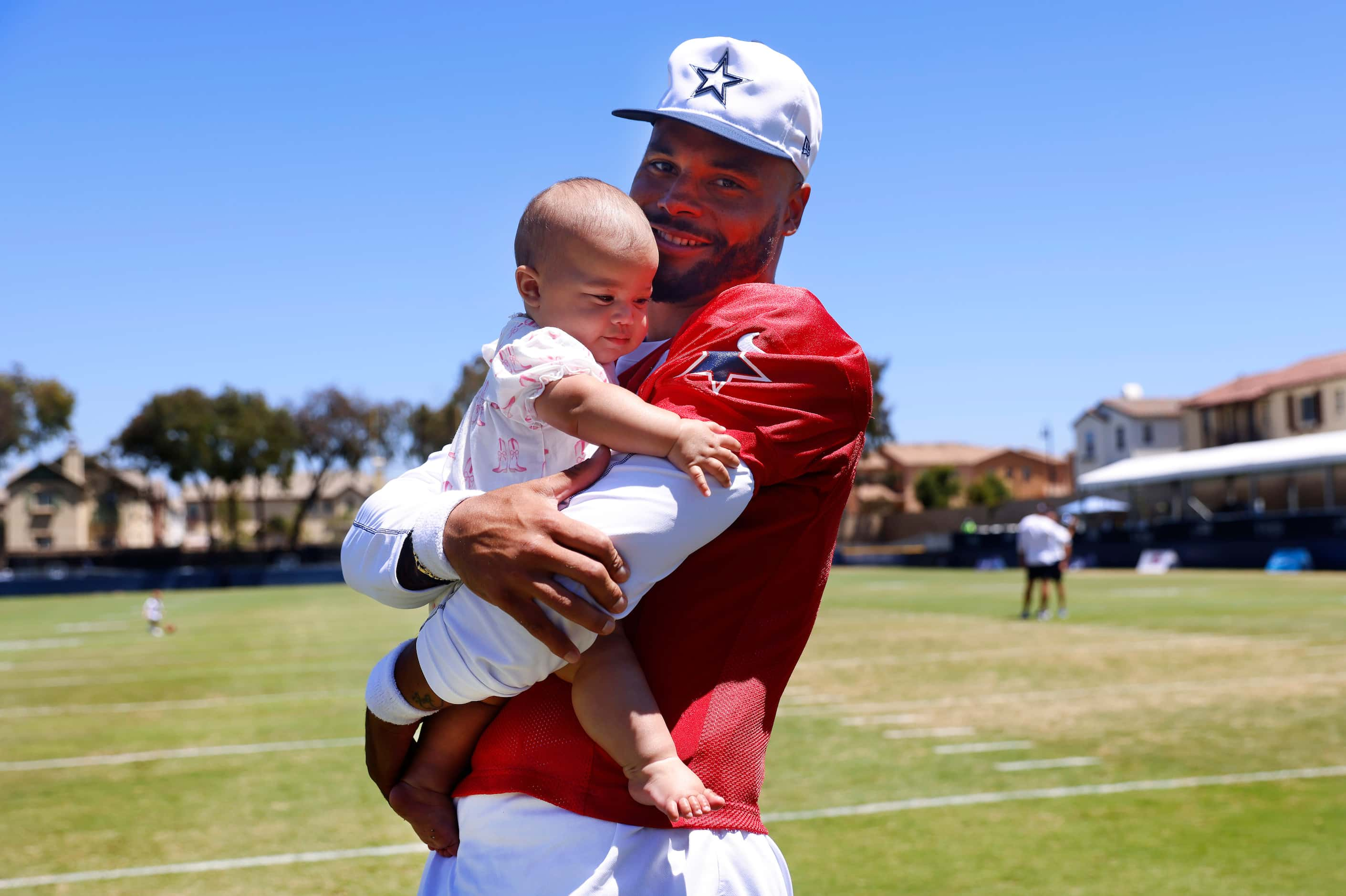 Dallas Cowboys quarterback Dak Prescott plays with his baby daughter Margaret Jane Rose...