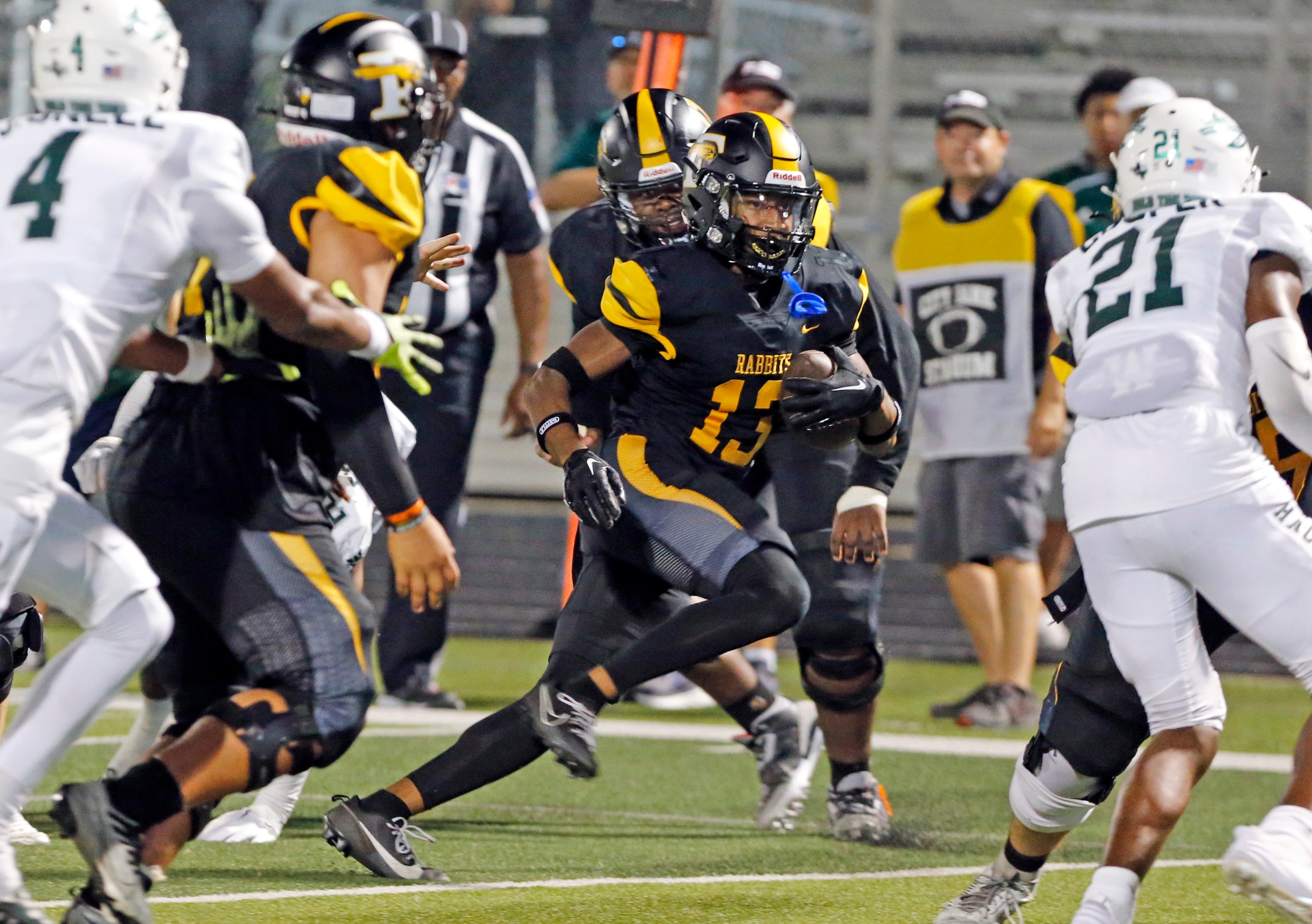 Forney high WR Preston Jackson (13) finds a gap in the Waxahachie high defense and heads to...