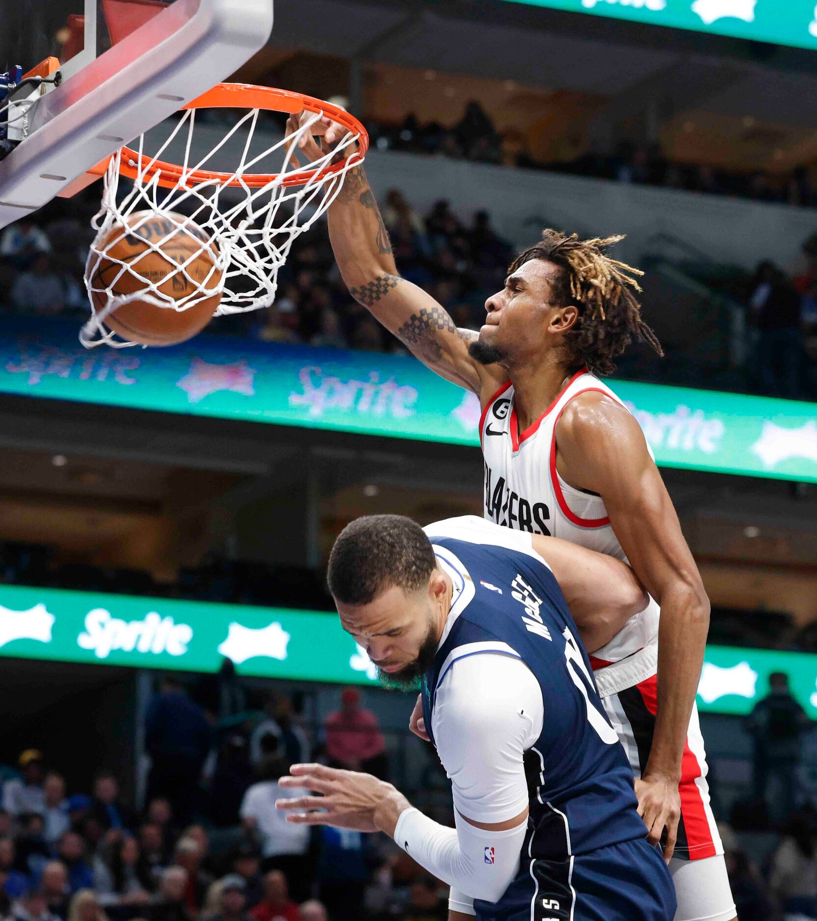 Portland Trail Blazers forward Greg Brown III (4) dunks over Dallas Mavericks center JaVale...