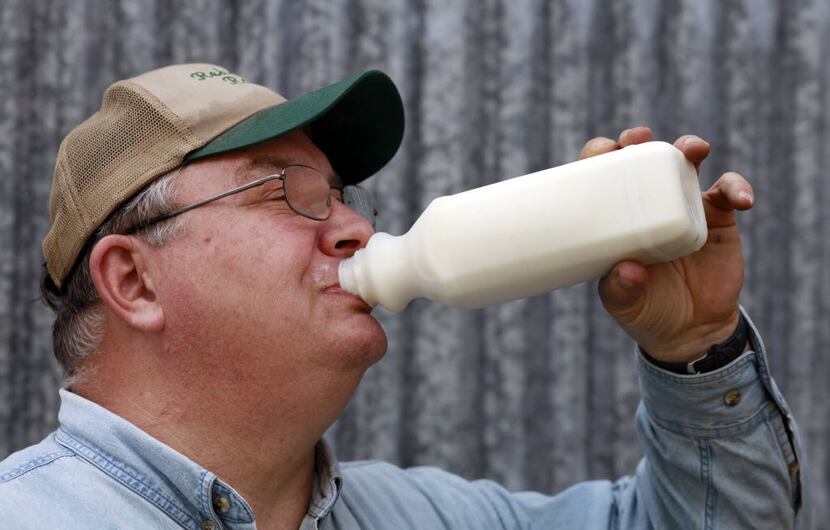 Robert Hutchins takes a drink of his raw goat milk on his ranch, Rehoboth Ranch, close to...