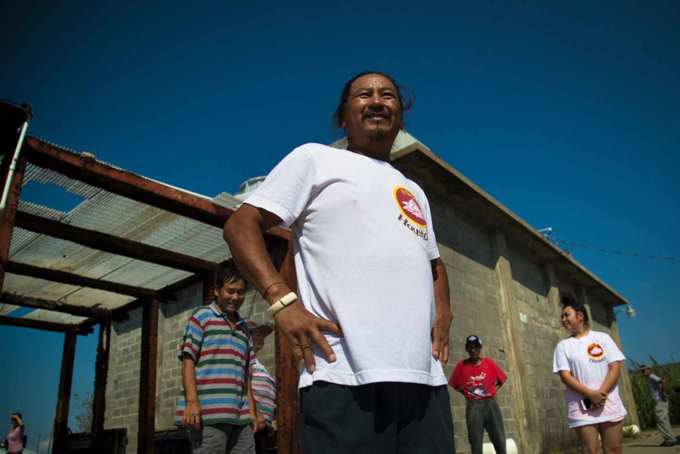 Cong Tu Huynh stands on a dock with fellow fishermen who have found themselves without a job...