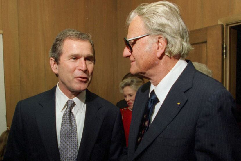 George  W. Bush talks with Billy Graham before a prayer service in Austin before Bush was...