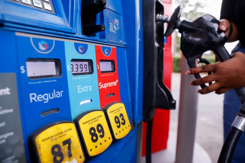 Samira McGowan puts back the pump after filling up on gas on Wednesday, Oct. 20, 2021, at an...