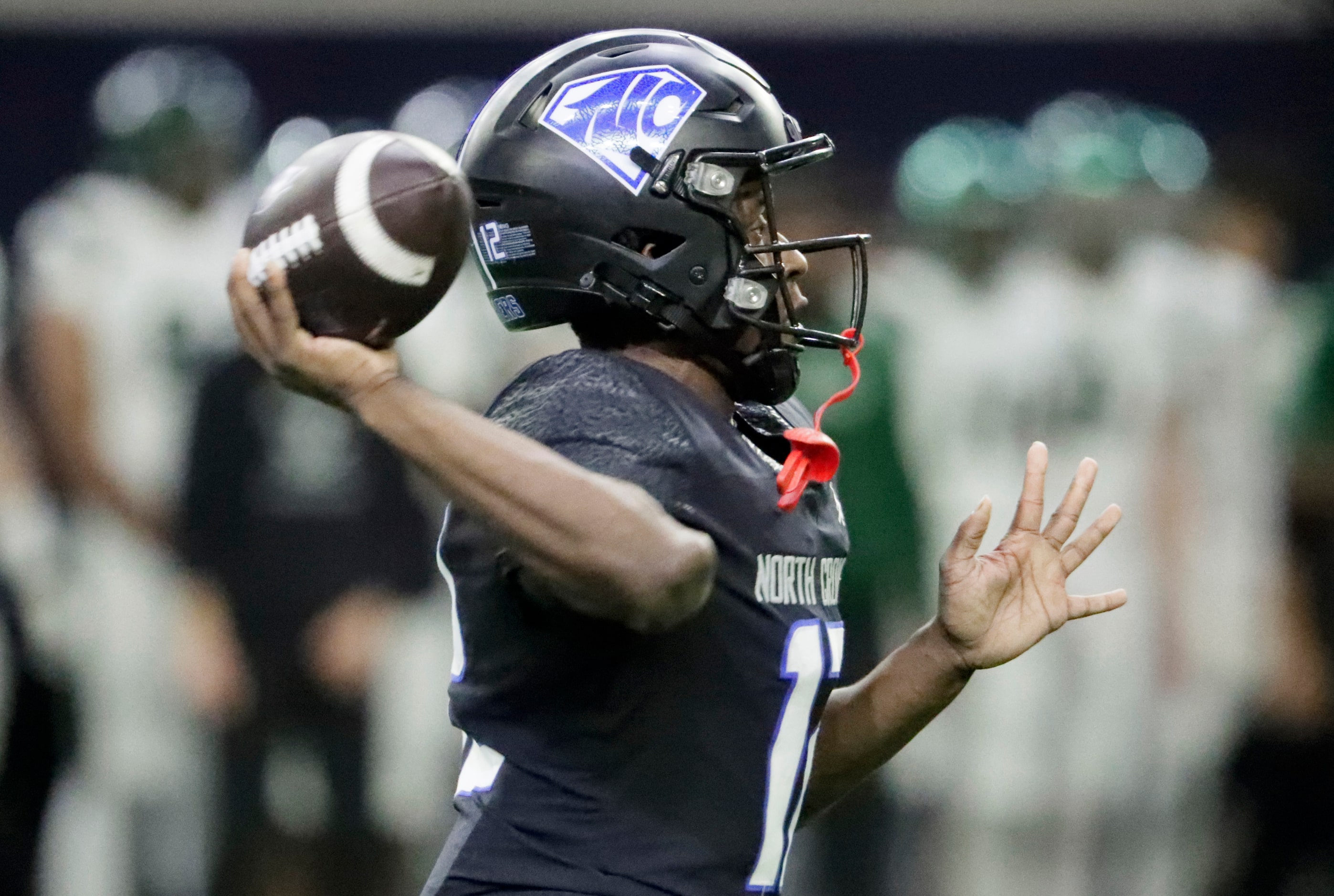 North Crowley High School quarterback Chris Jimerson (12) throws a pass during the first...