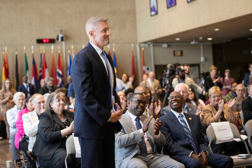 Council member and veteran Chad West stands as he is introduced during a news conference...