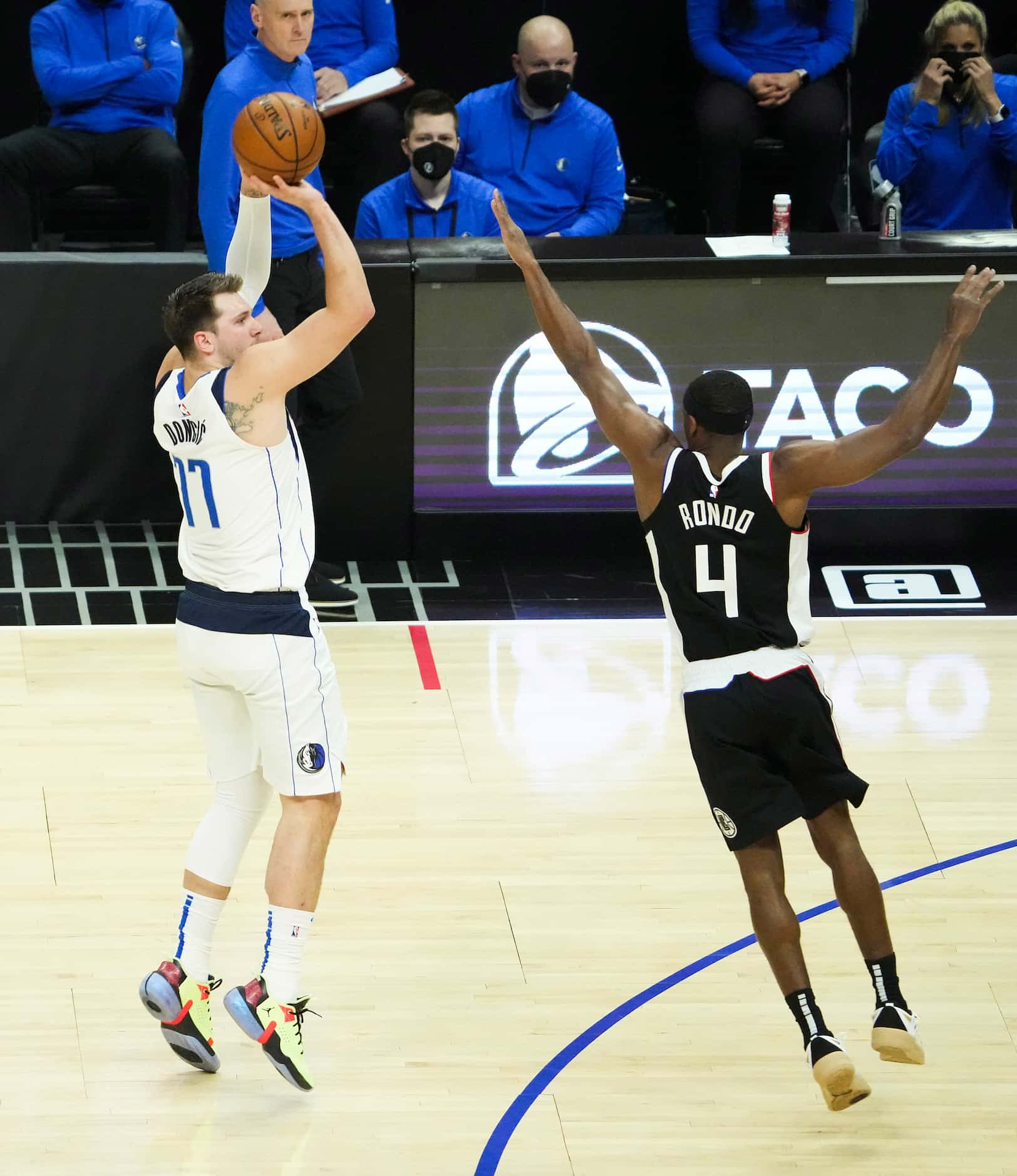 Dallas Mavericks guard Luka Doncic (77) shoots a 3-pointer over LA Clippers guard Rajon...