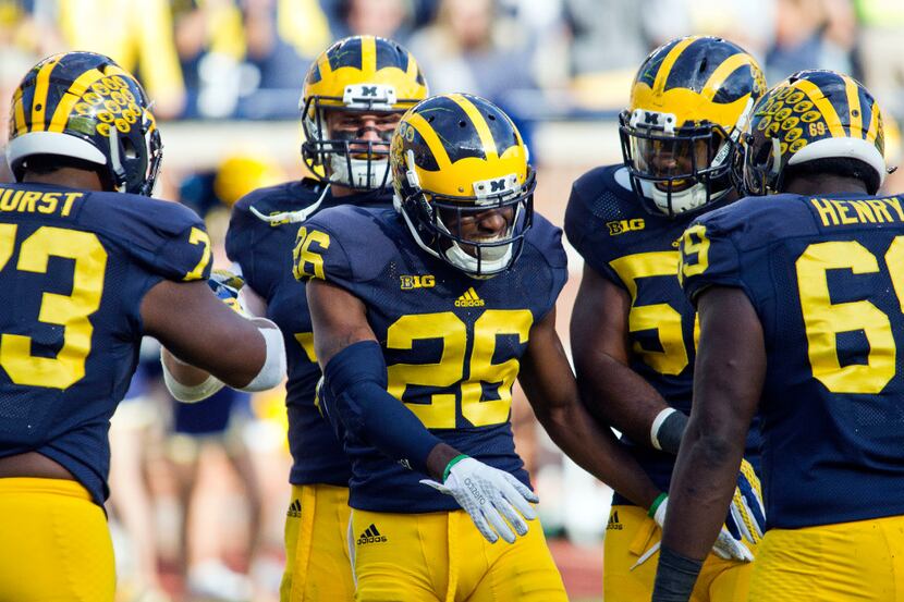 Michigan defensive back Jourdan Lewis (26) celebrates his touchdown from interception in the...
