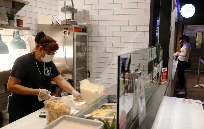 Noemi Hernandez works on making banana pudding
at Roots Chicken Shak at Legacy Food Hall in...