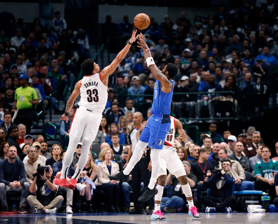 Dallas Mavericks guard Kyrie Irving (11) puts up and makes three-pointer over Portland Trail...