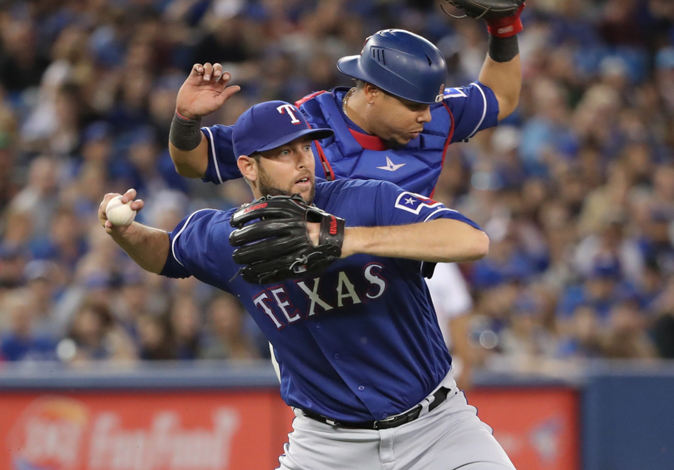 TORONTO, ON - APRIL 27: Chris Martin #31 of the Texas Rangers throws out the baserunner as...