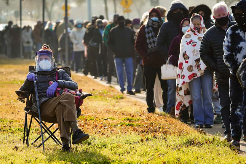 Florence Mullins, 89, sat in a chair as a family member held her place in the long line to...