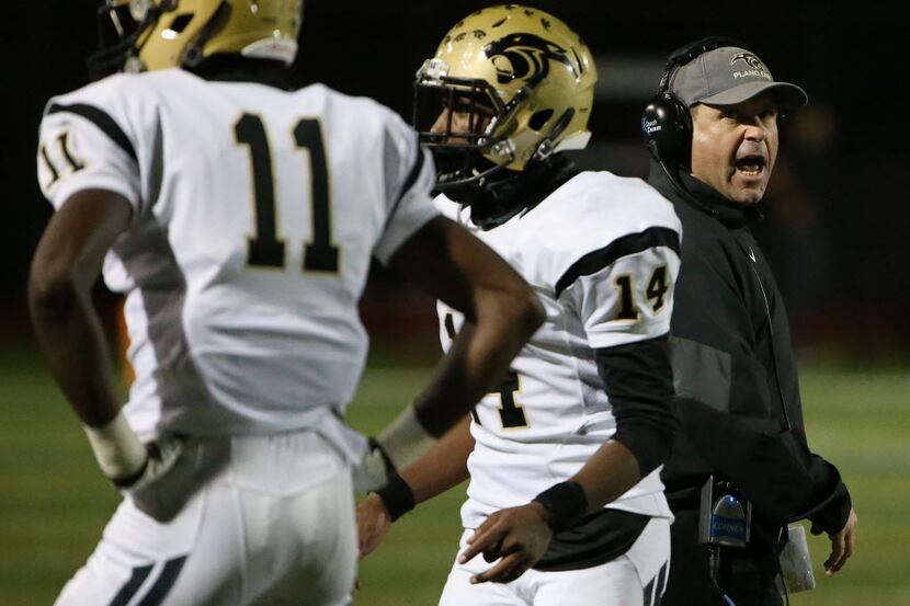 Plano East head coach Joey McCullough speaks to his players during a high school football...