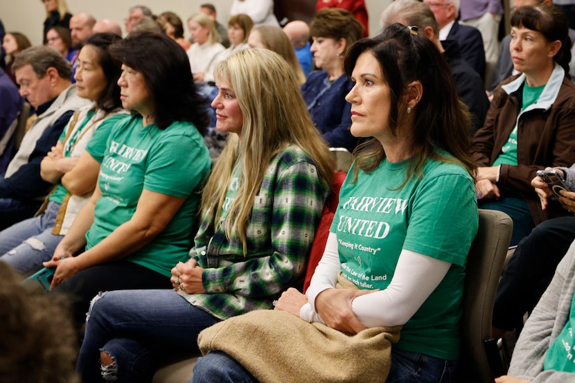 Fairview resident Alycia Kuehne, right ,listens during a town council meeting at Fairview...