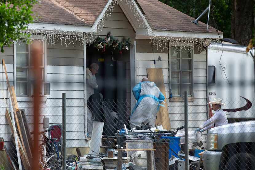 Law enforcement authorities removed bodies Saturday from a home where five people were shot...