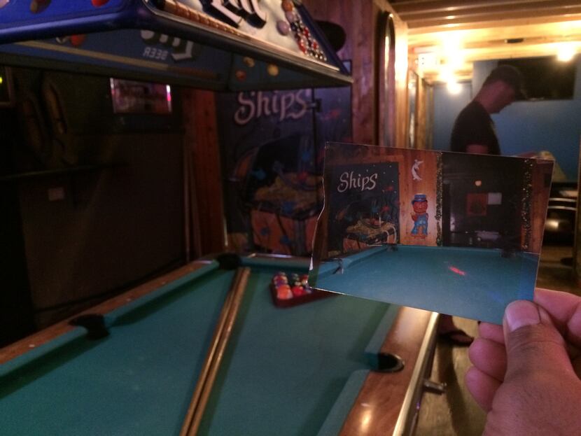 Ships' new owner retained the original pool table, too. Matt Pikar holds a picture from...