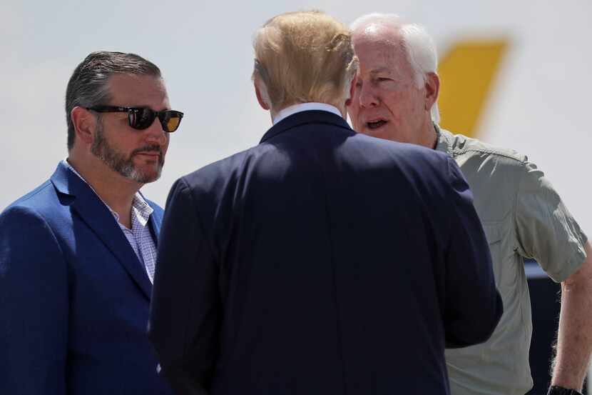 President Donald Trump talks with Sen. John Cornyn, R-Texas, right, and Sen. Ted Cruz,...