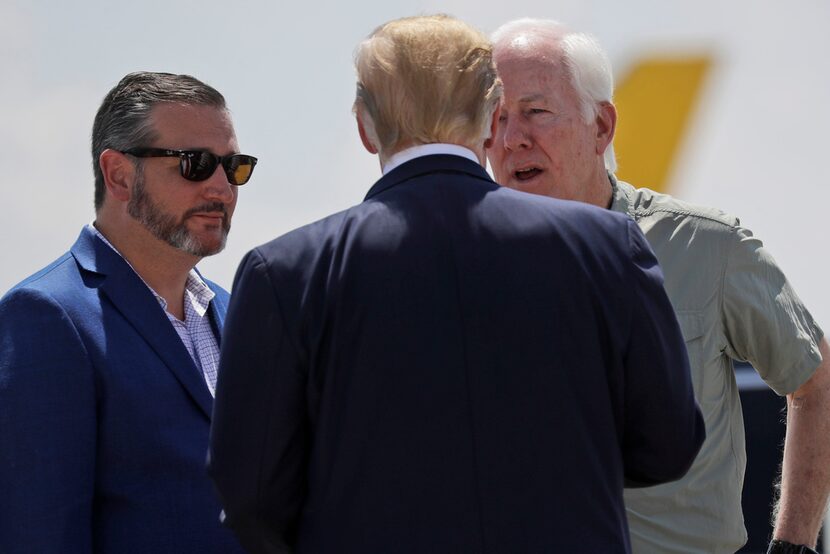 President Donald Trump talks with Sen. John Cornyn, R-Texas, right, and Sen. Ted Cruz,...