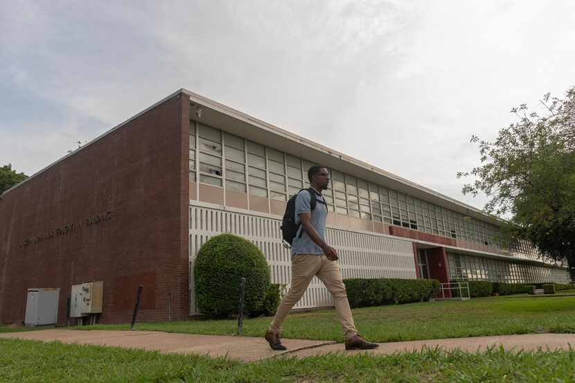 Cameron Johnson, a business student at Paul Quinn College, walks past a building that will...