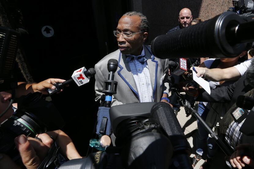 John Wiley Price is mobbed by reporters as he emerges from his initial court appearance...