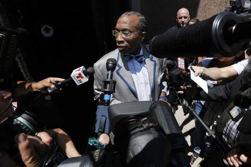 John Wiley Price is mobbed by reporters as he emerges from his initial court appearance...
