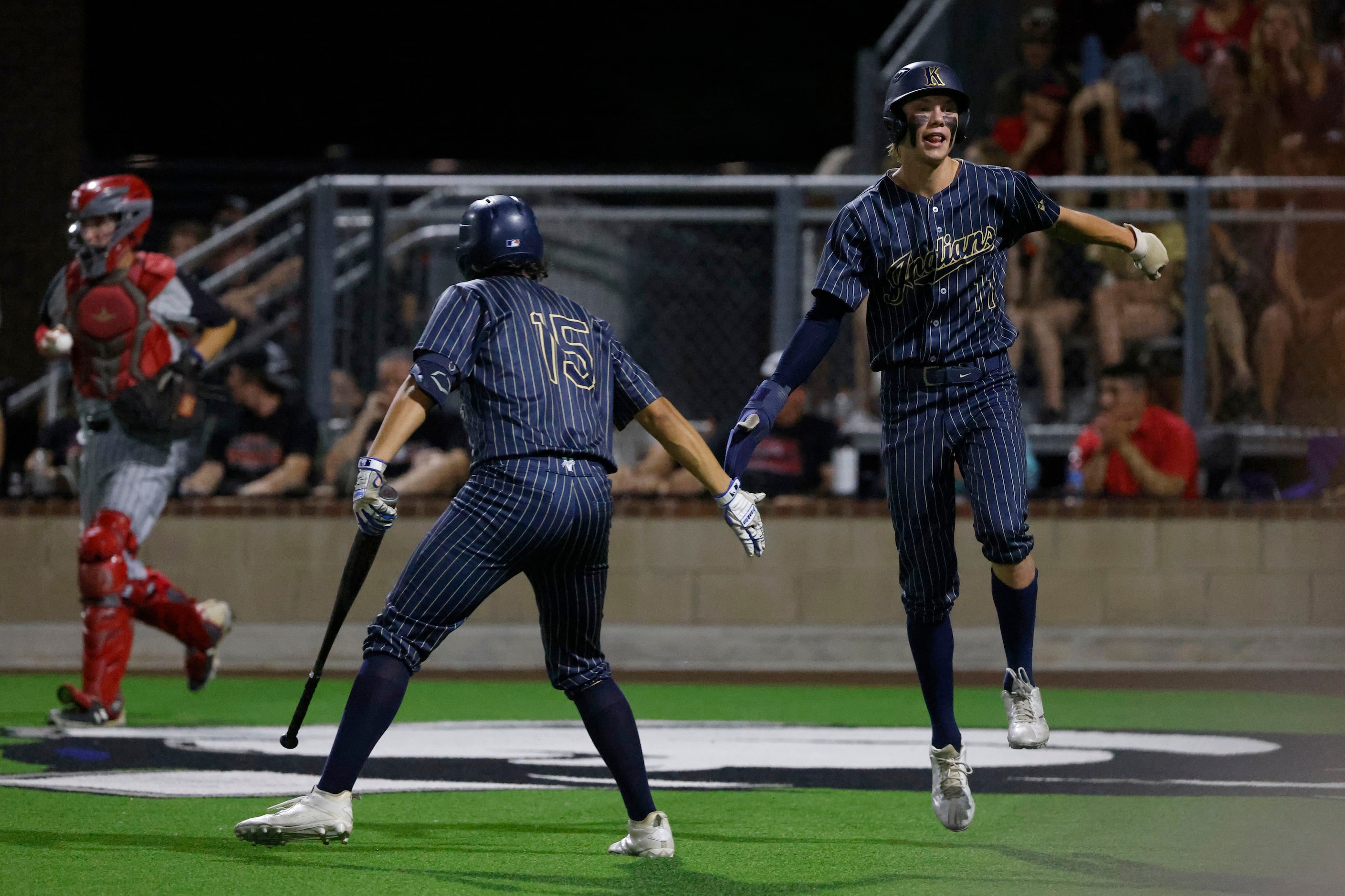 Keller’s Braden Simmons, right, is congratulated by Michael Dattalo, 15, aft he scored...