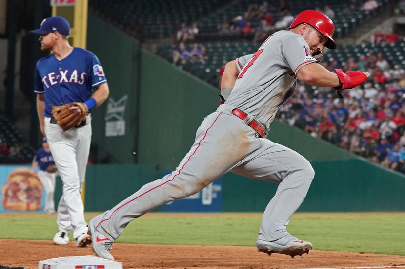 Los Angeles Angels 'Mike Trout rounds third base as he heads home to score during the sixth...