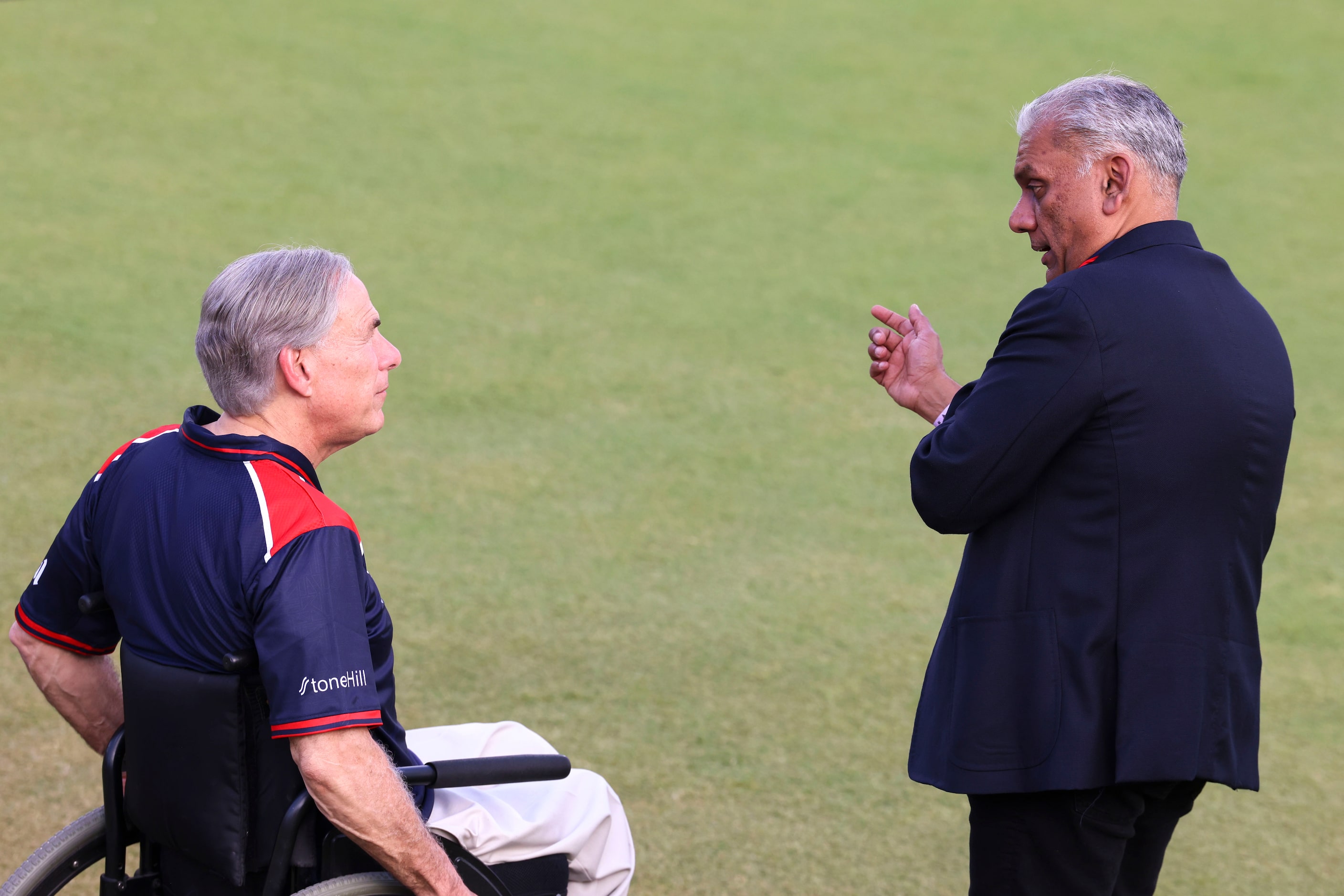 Texas governor Greg Abbott  (left) talks to Major League Cricket investor and co-owner of...