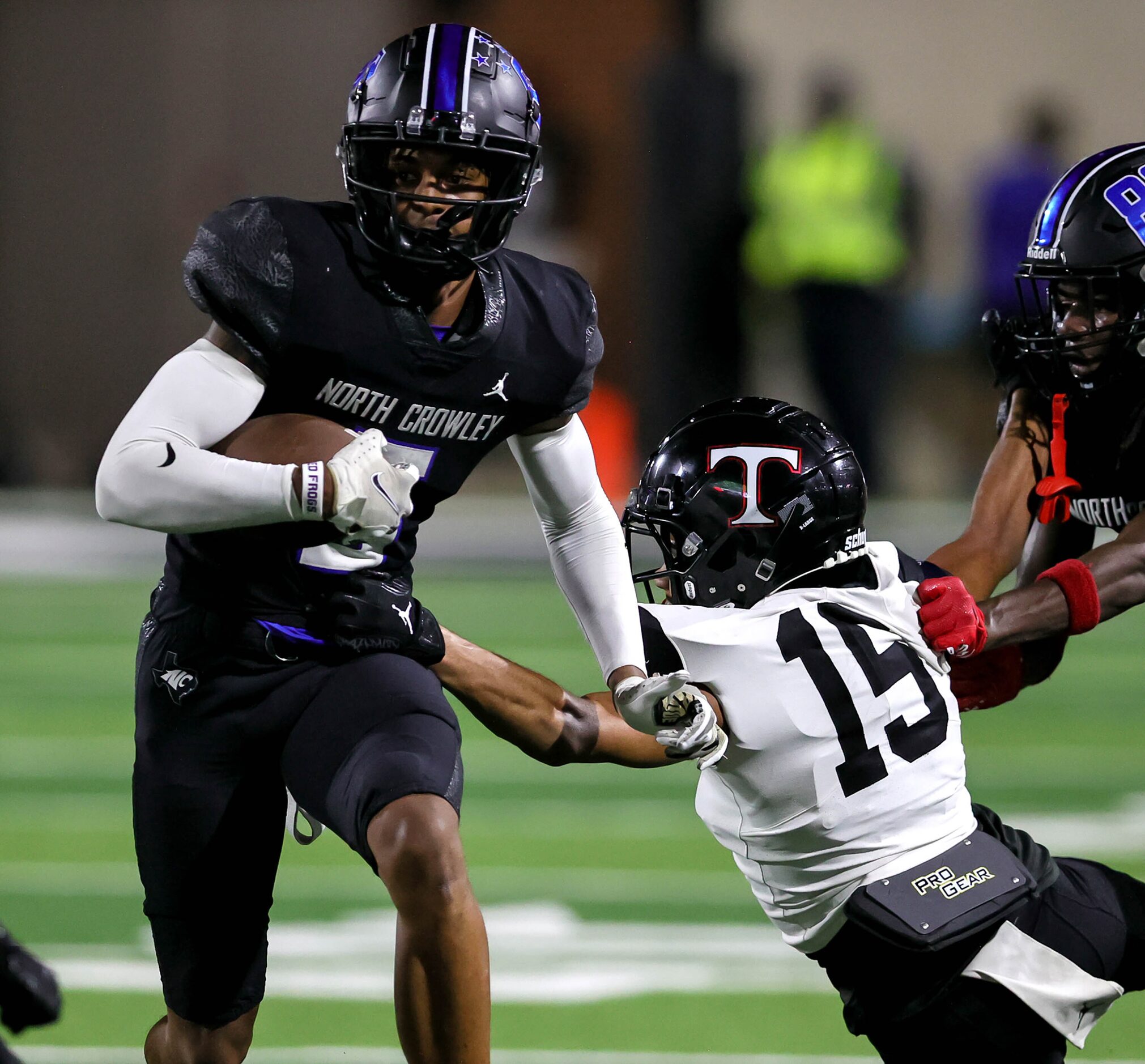 North Crowley wide receiver Julian Knox (left) finds room to run against Euless Trinity...