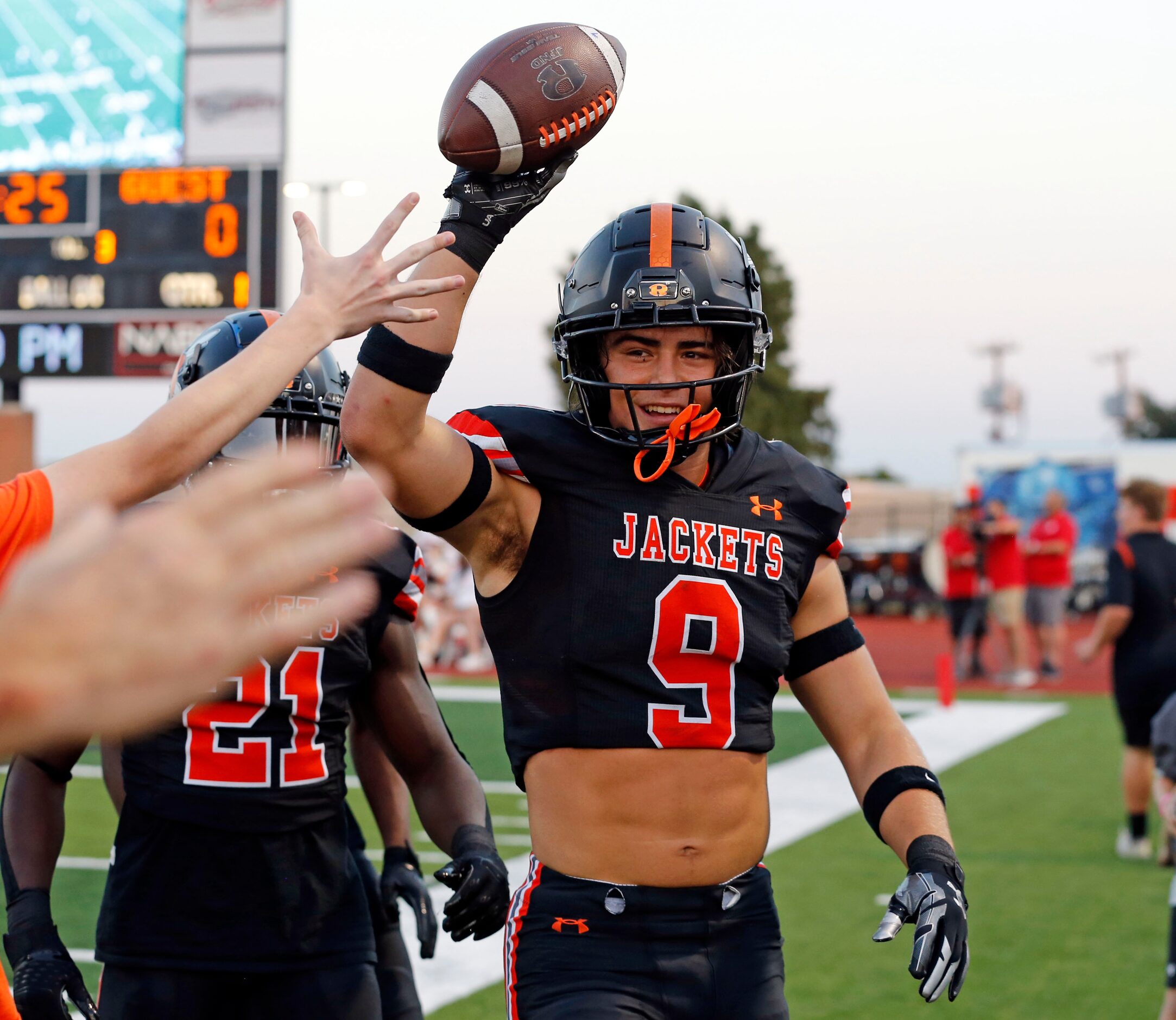 Rockwall high’s Jarrett Stoner (9) holds the ball high, after recovering a muffed kickoff...